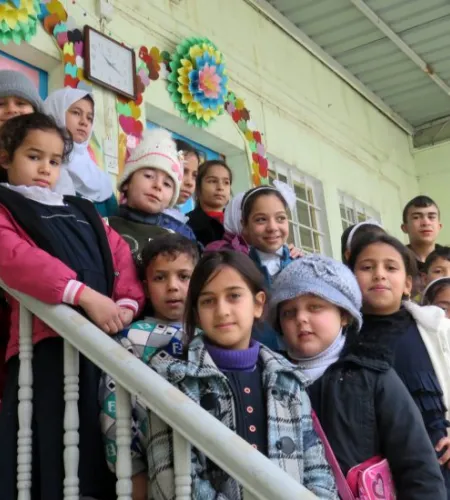 Kinder stehen auf einer Treppe vor dem Mashahad Gemeinezentrum in Mosul
