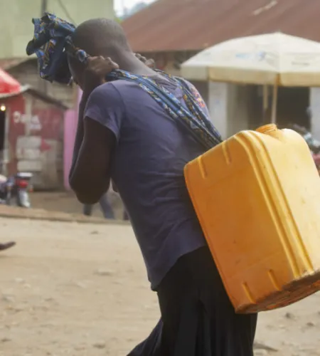 Woman carrying a heavy load in DR Congo